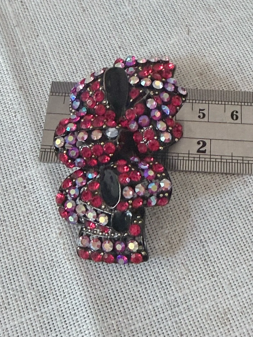 red rhinestone bow hair claw clip embellished with sparkling red and aurora bore
